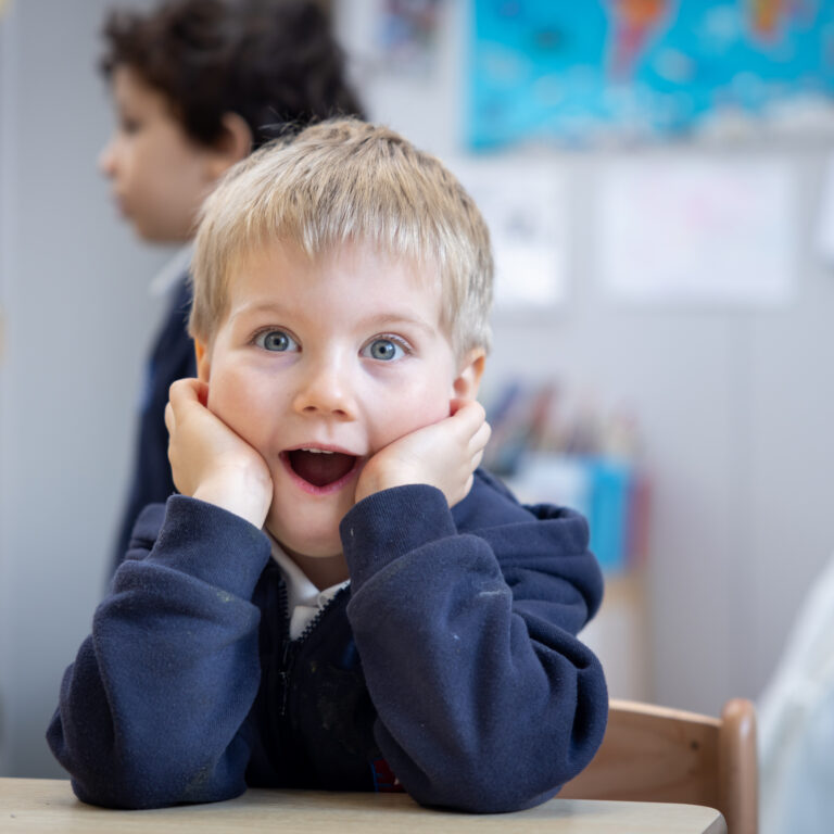 A young male student pulling a silly face at the Knightsbridge School private preschool